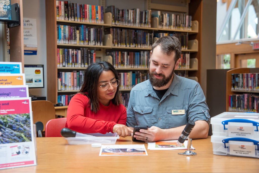 Two people exploring a citizen science kit at a library. CC BY-NC-SA 4.0