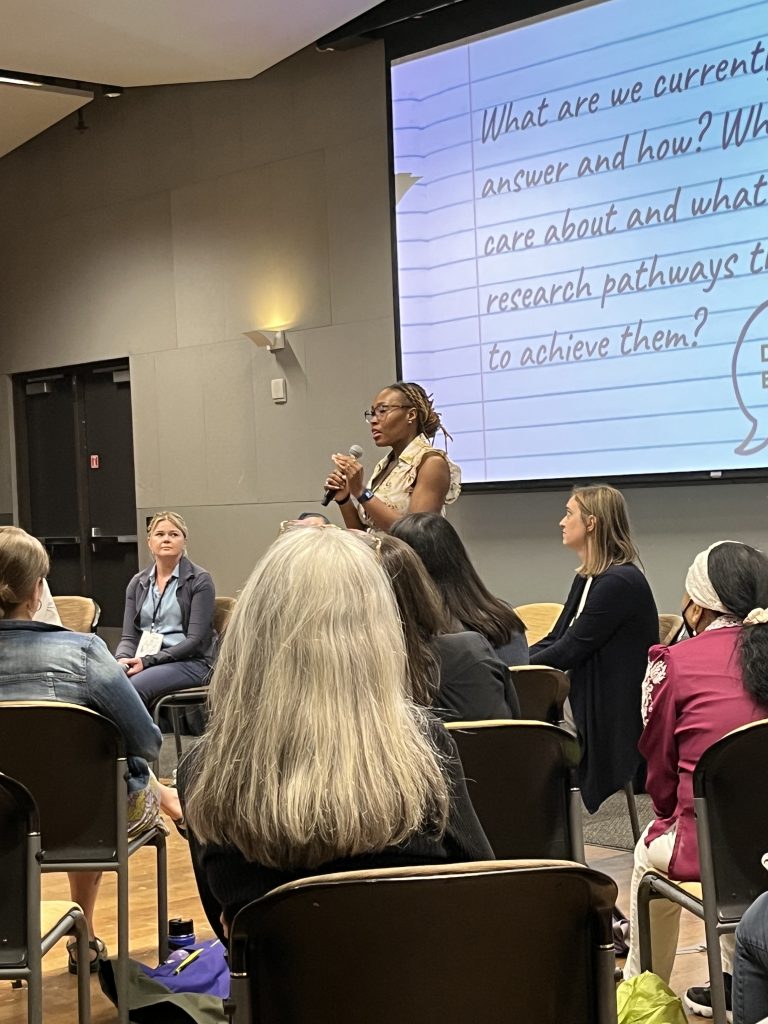 Graduate student Deja Perkins sharing during a fishbowl symposium on co-developing a research agenda for the next 10 years at C*Sci 2023.